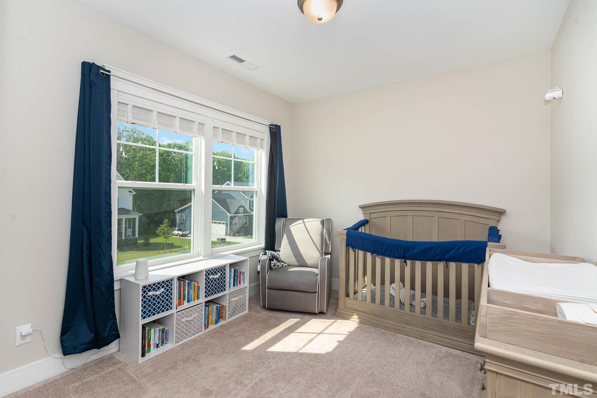 2816 Flume Gate Drive Raleigh, NC 27603 - Photo 22 of 45 a bedroom with furniture and a window