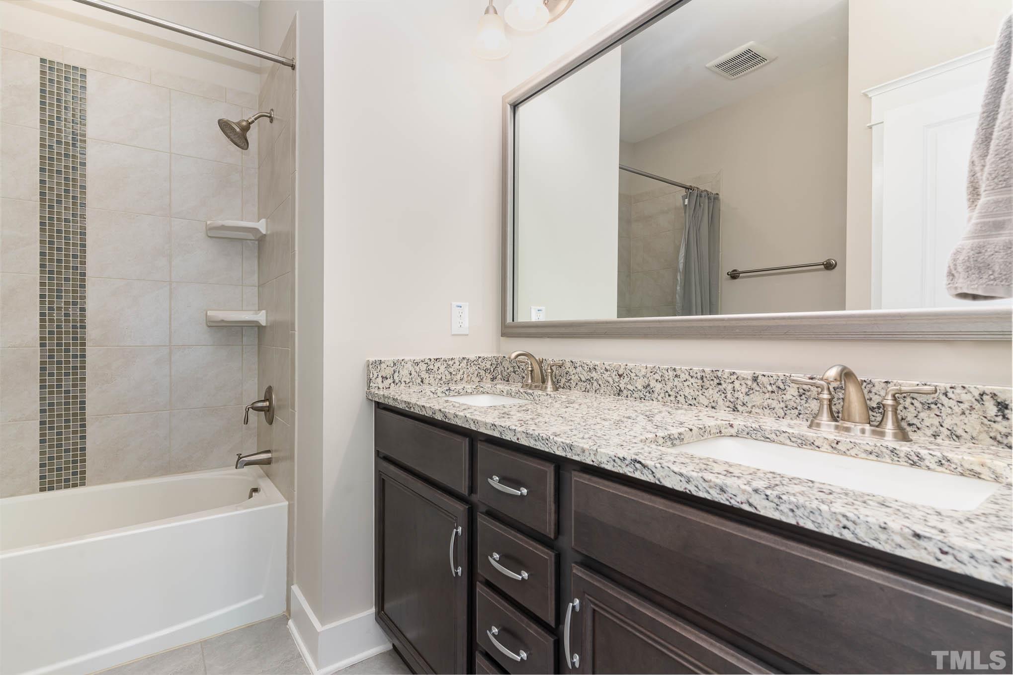 2816 Flume Gate Drive Raleigh, NC 27603 - Photo 24 of 45 a bathroom with a granite countertop bathtub sink vanity and mirror