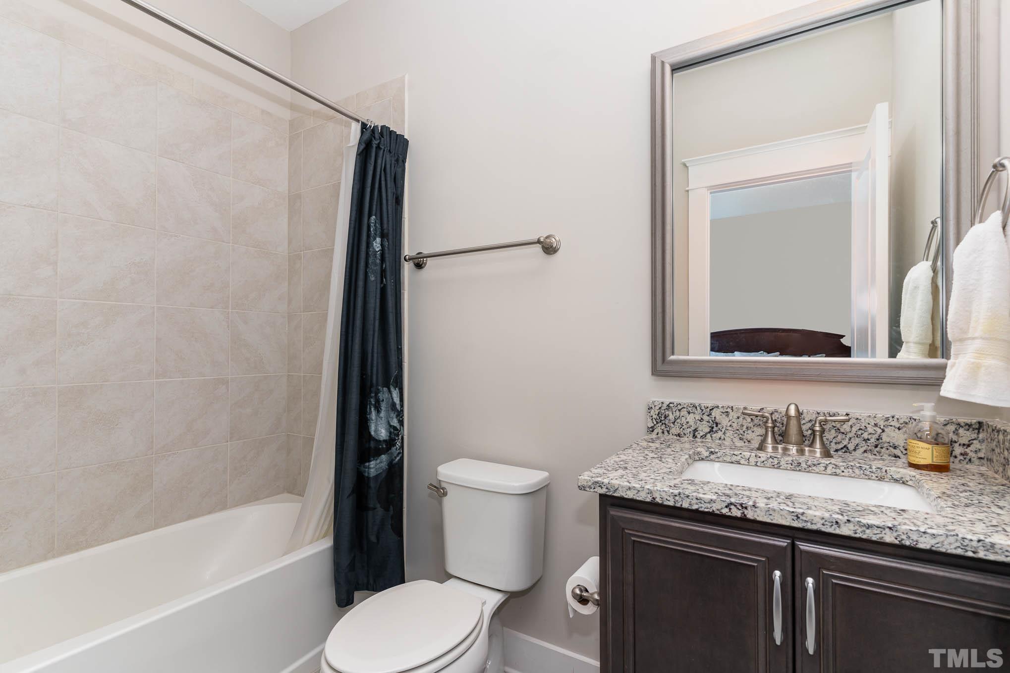 2816 Flume Gate Drive Raleigh, NC 27603 - Photo 27 of 45 a bathroom with a granite countertop sink toilet and shower