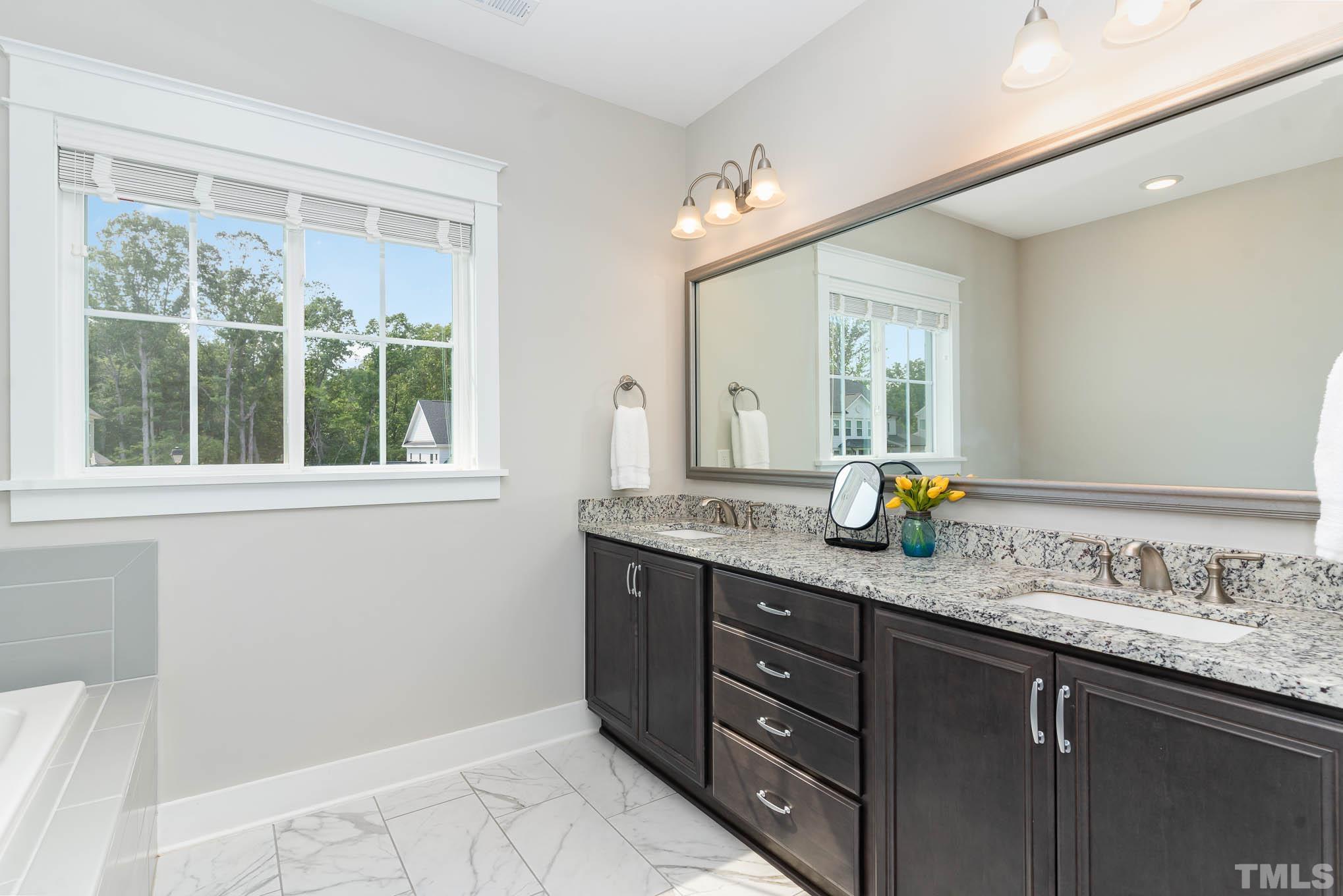 2816 Flume Gate Drive Raleigh, NC 27603 - Photo 30 of 45 a bathroom with a granite countertop sink mirror and window