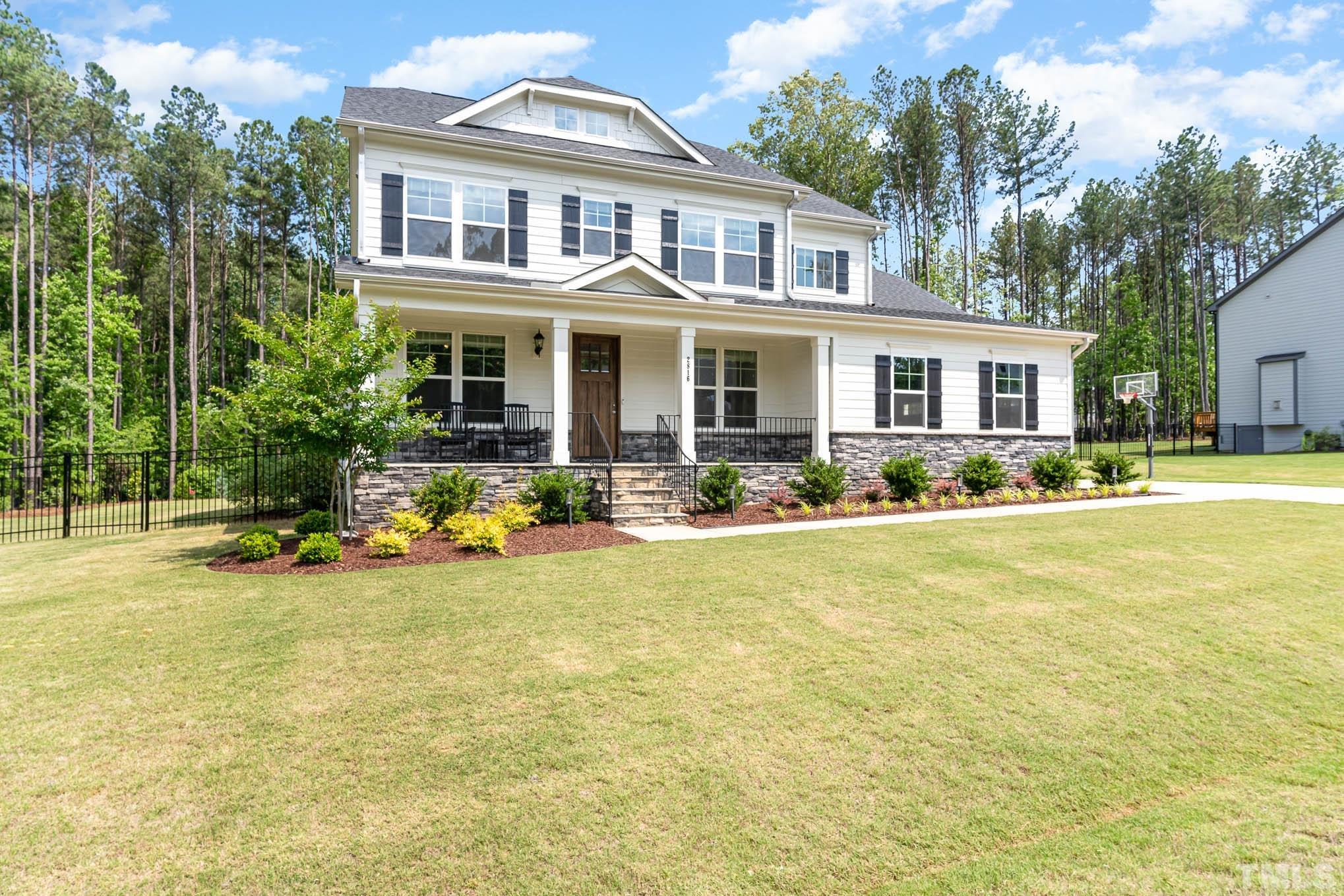 2816 Flume Gate Drive Raleigh, NC 27603 - Photo 3 of 45 a front view of a house with swimming pool and porch