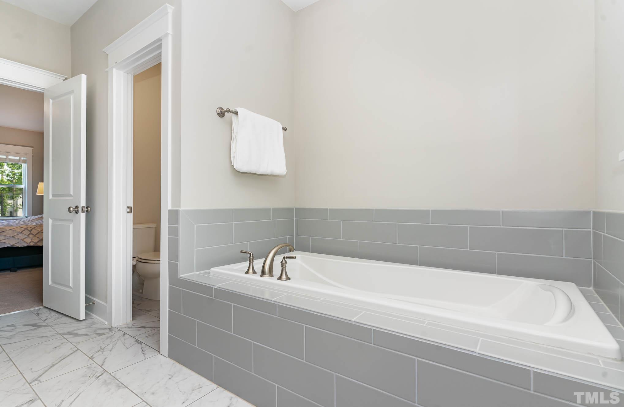 2816 Flume Gate Drive Raleigh, NC 27603 - Photo 31 of 45 a bathroom with a bathtub