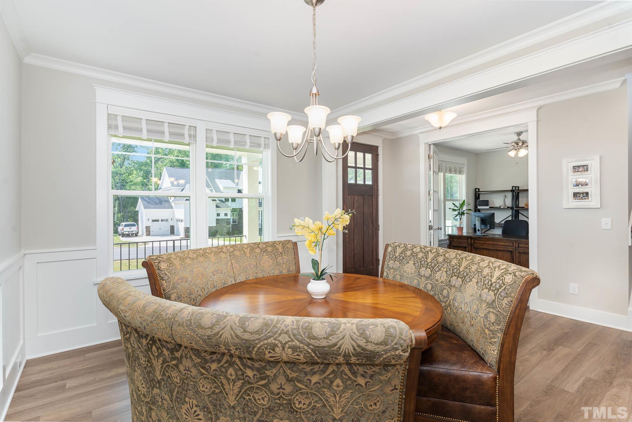 2816 Flume Gate Drive Raleigh, NC 27603 - Photo 9 of 45 a dining room with furniture a chandelier and wooden floor