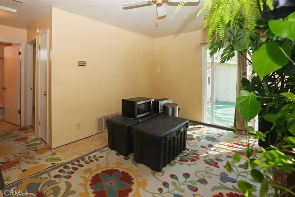 a bedroom with a bed and a plant