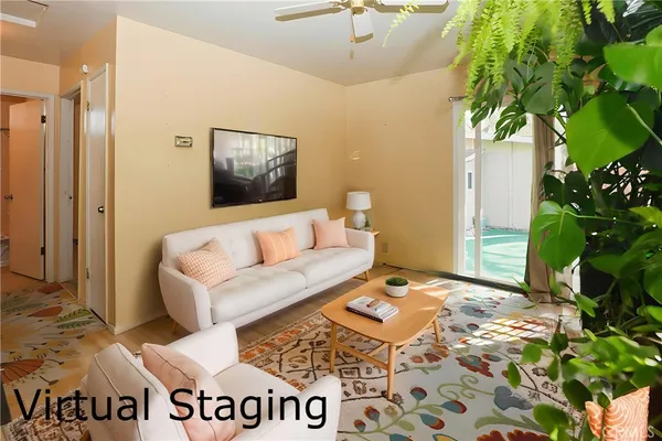 a living room with a couch and a potted plant