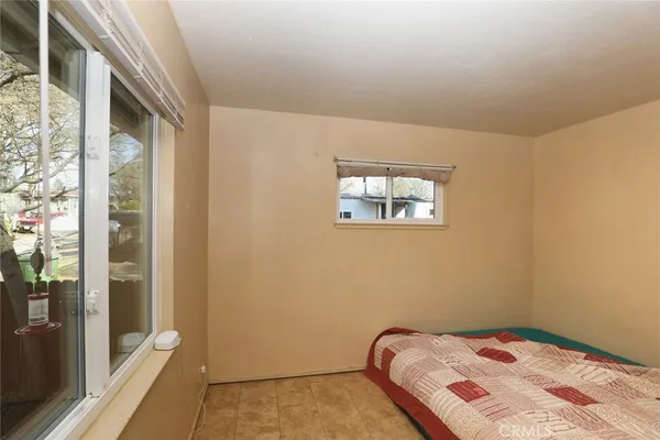 a bedroom with a bed and a window