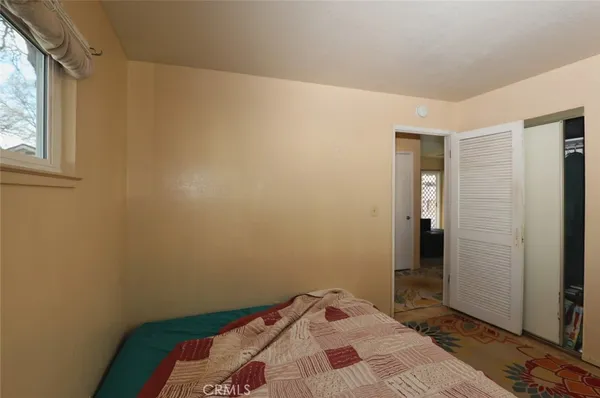 a bedroom with a bed and a window