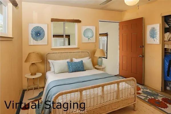a bedroom with a bed mirror and a window