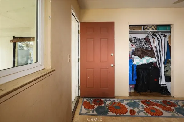 a view of walk in closet with clothes
