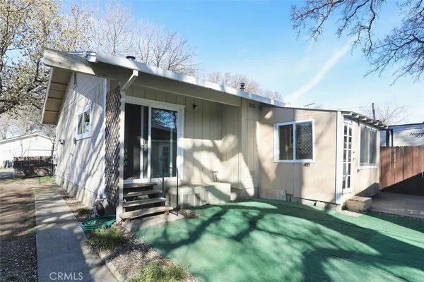 a view of a house with a yard covered in snow