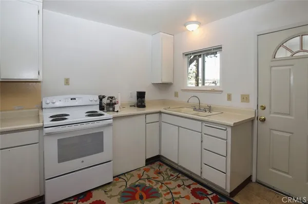 a kitchen with a sink stove and cabinets