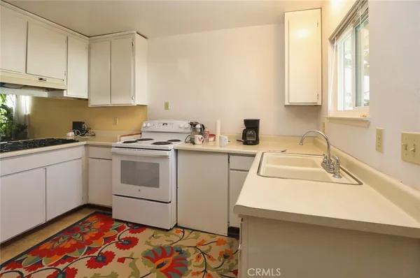 a utility room with sink dryer and washer
