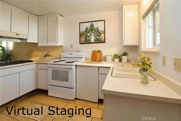 a kitchen with a sink a stove and cabinets