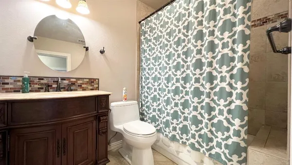 a bathroom with a sink toilet and mirror