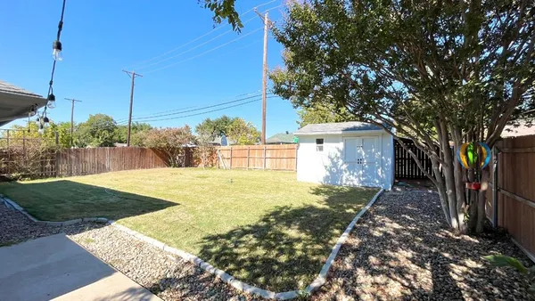 a view of a yard with potted plants