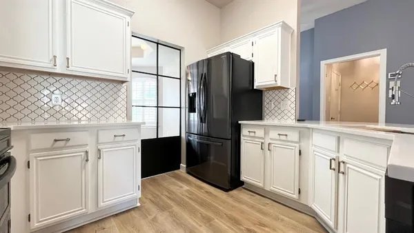 a kitchen with stainless steel appliances a refrigerator sink and cabinets
