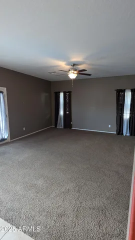 a spacious bathroom with a mirror and a sink