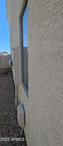 an empty room with windows and chandelier fan