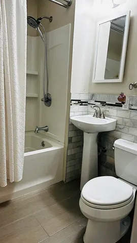 a bathroom with a sink toilet and shower