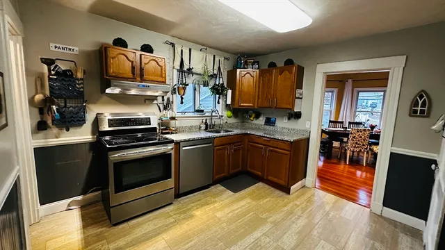 a kitchen with stainless steel appliances granite countertop a stove and a sink