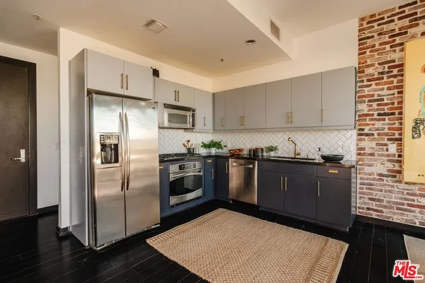 a stove top oven sitting inside of a kitchen