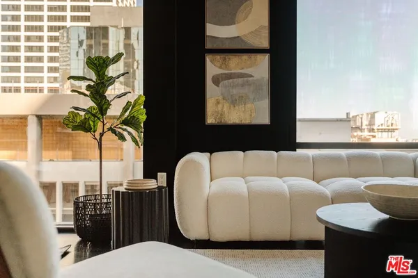 a living room with fireplace furniture and a large window