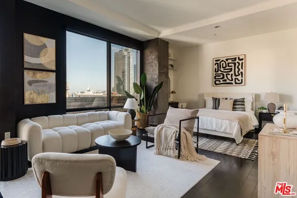 a bedroom with a bed wooden floor and a rug