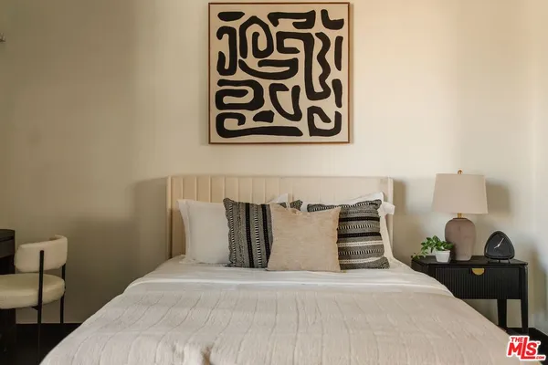 a bedroom with furniture and wooden floor
