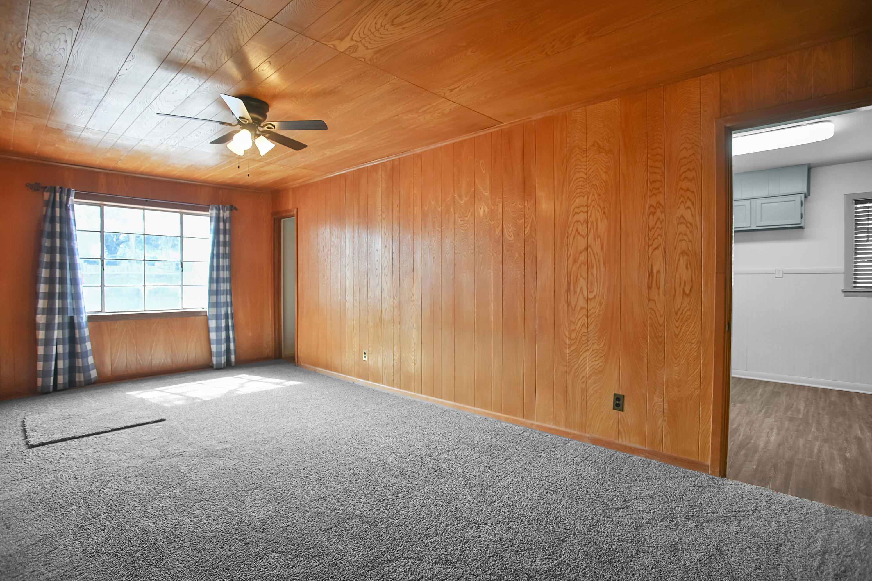 4309 31st Street Lubbock, TX 79410 - Photo 16 of 30 an empty room with chandelier fan and windows