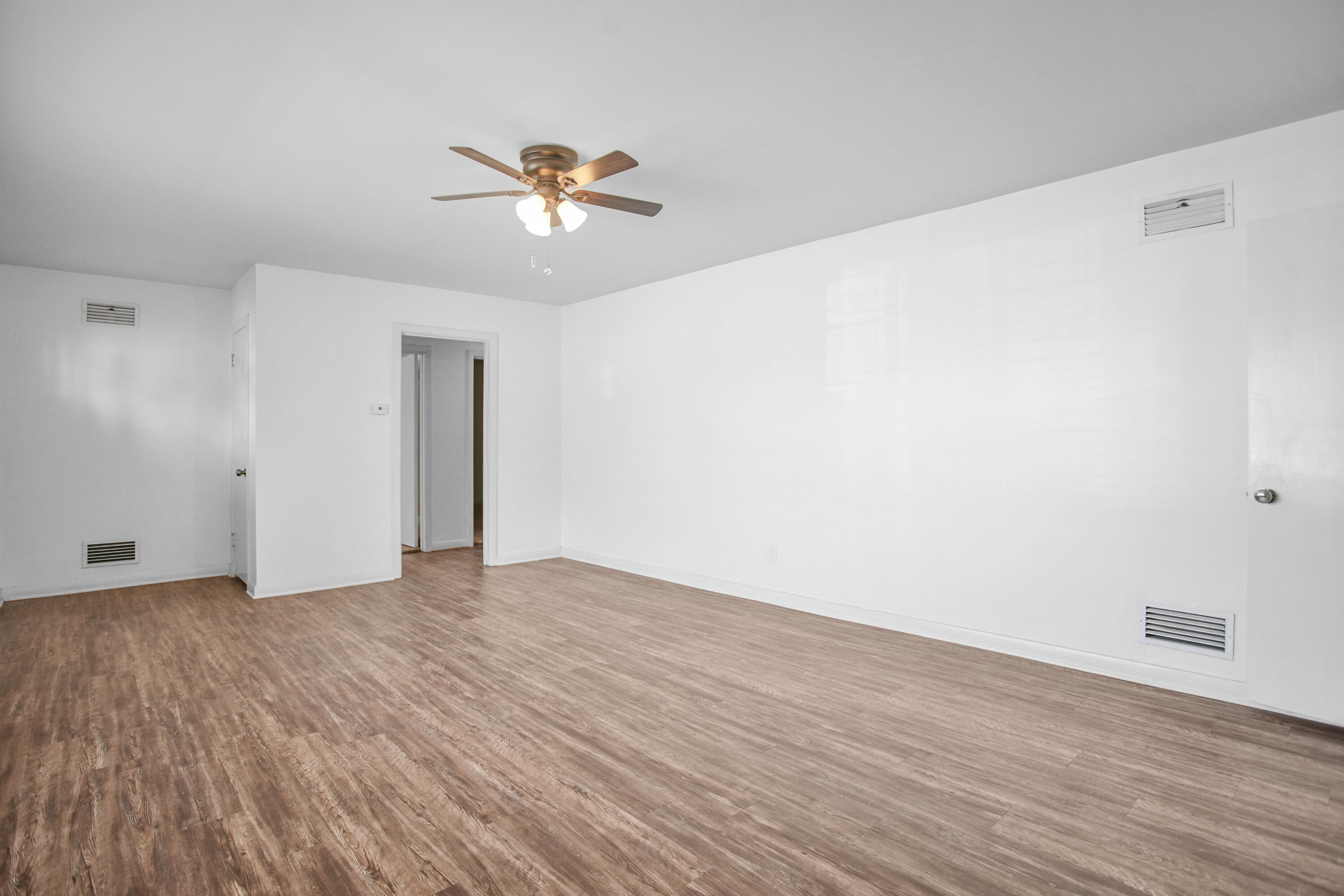 4309 31st Street Lubbock, TX 79410 - Photo 23 of 30 a view of an empty room with wooden floor