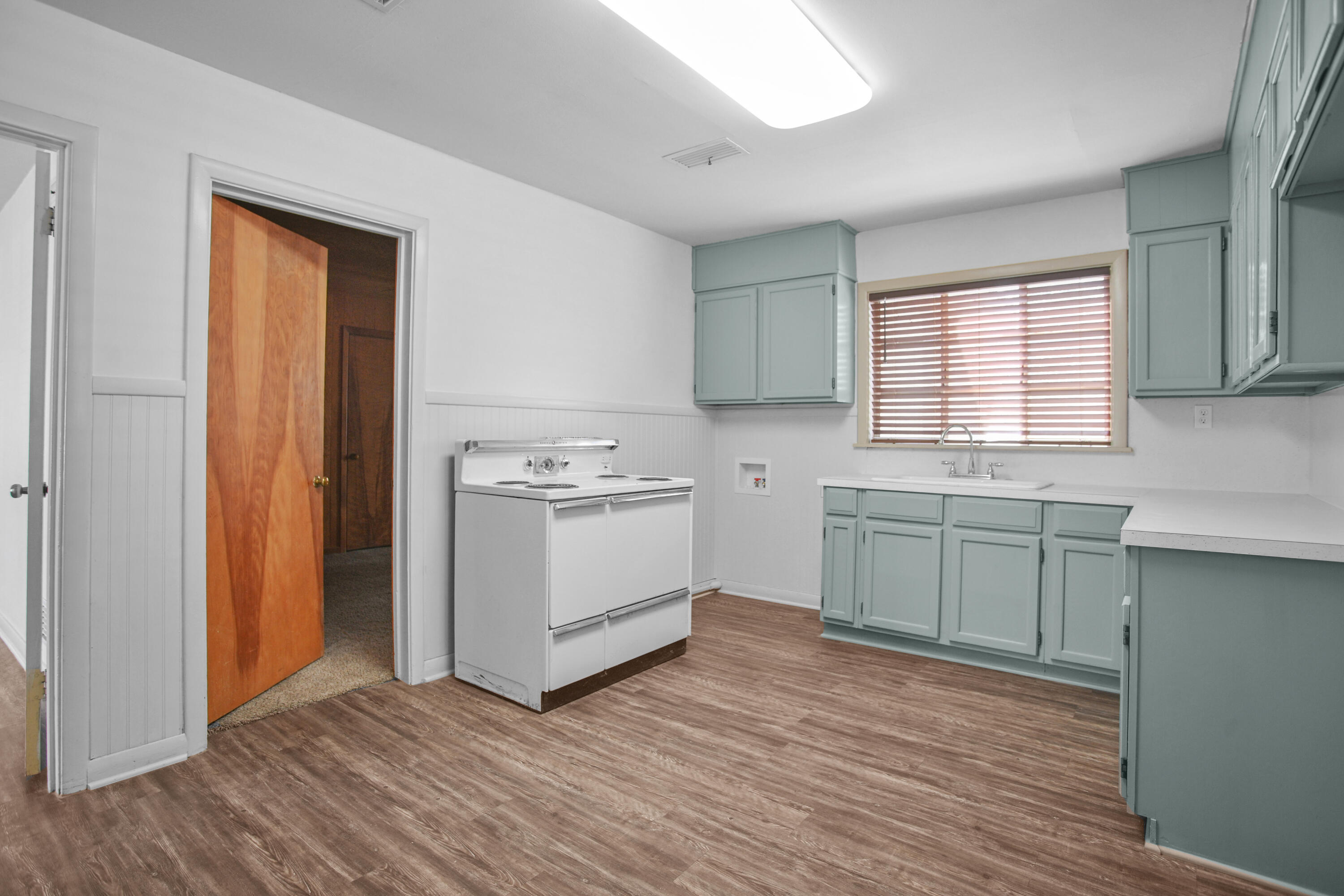 4309 31st Street Lubbock, TX 79410 - Photo 25 of 30 a kitchen with a white cabinets and sink
