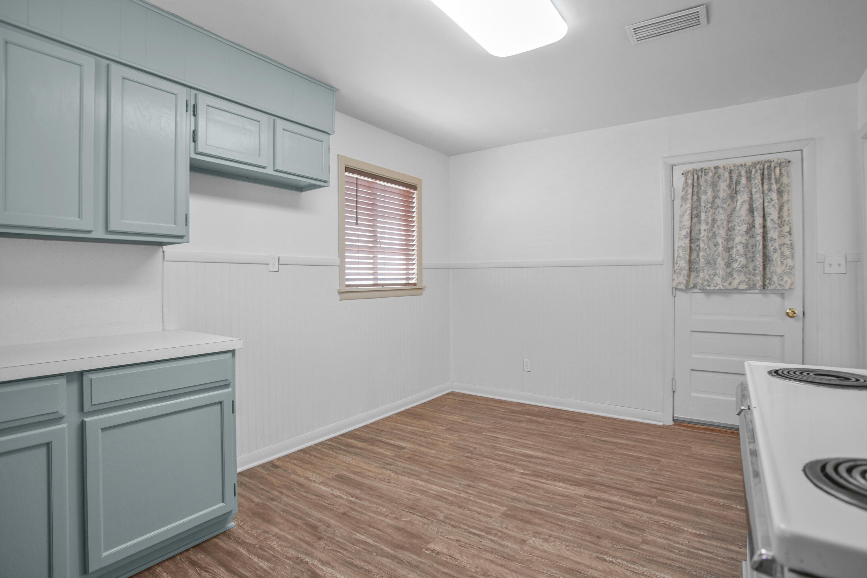 4309 31st Street Lubbock, TX 79410 - Photo 28 of 30 a room with a wooden floor and cabinets