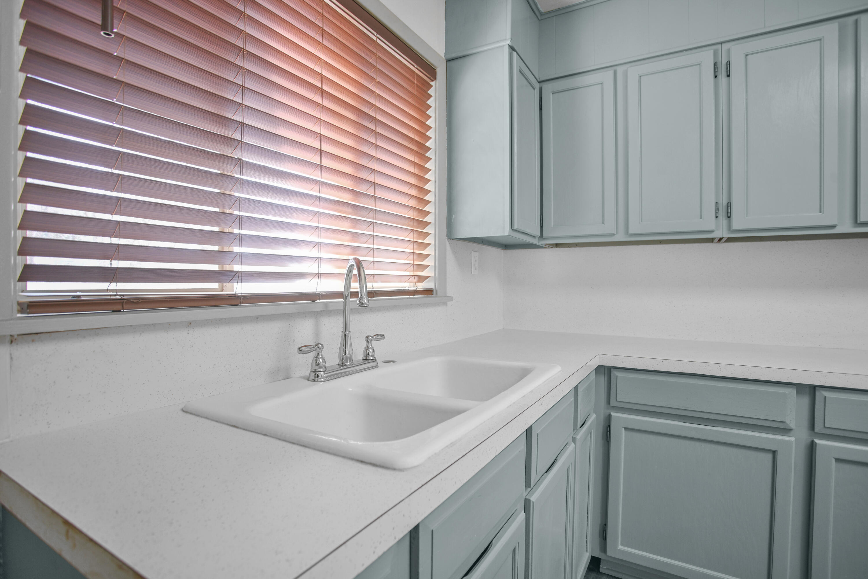 4309 31st Street Lubbock, TX 79410 - Photo 30 of 30 a kitchen with a sink and cabinets