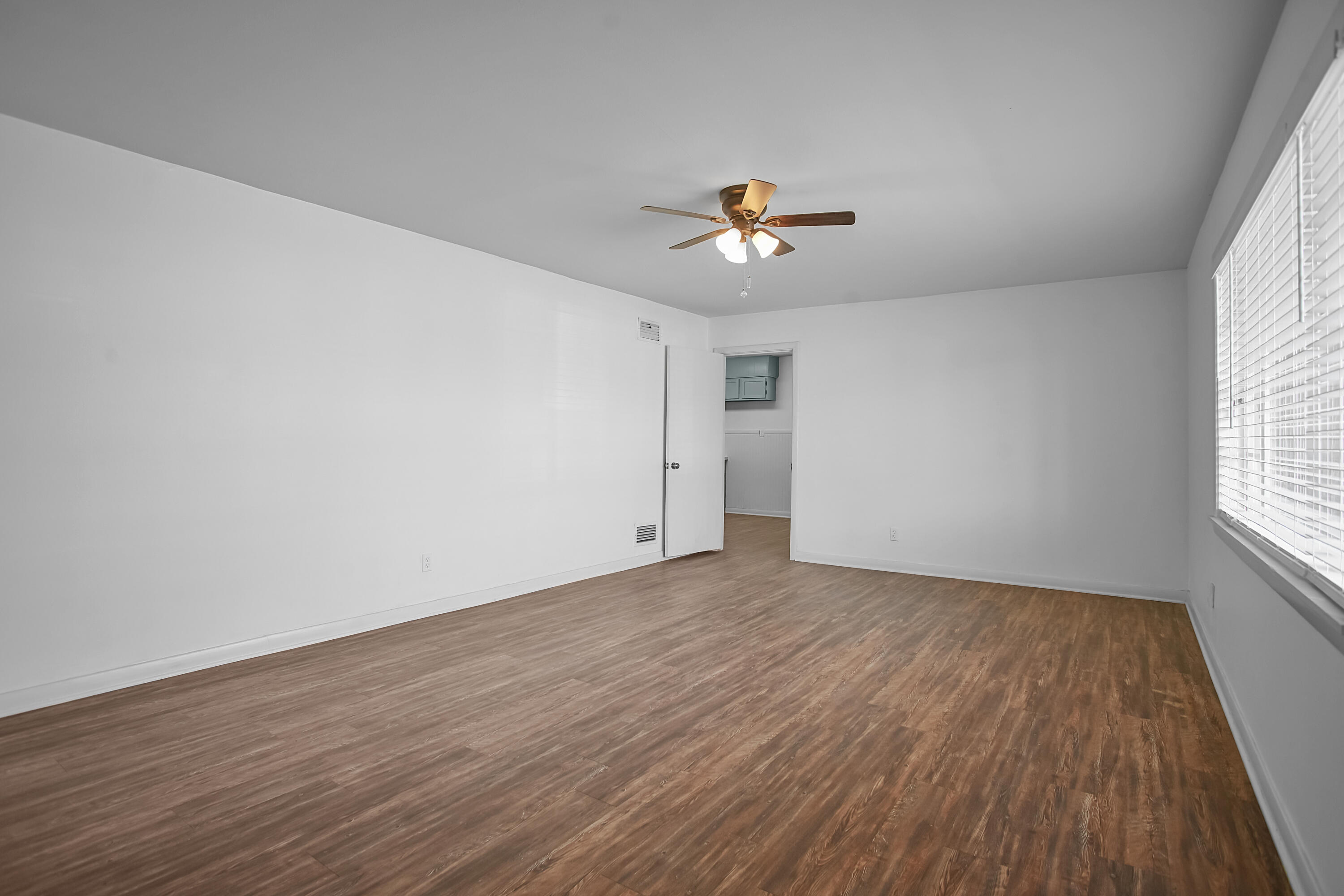 4309 31st Street Lubbock, TX 79410 - Photo 3 of 30 wooden floor in an empty room with a window