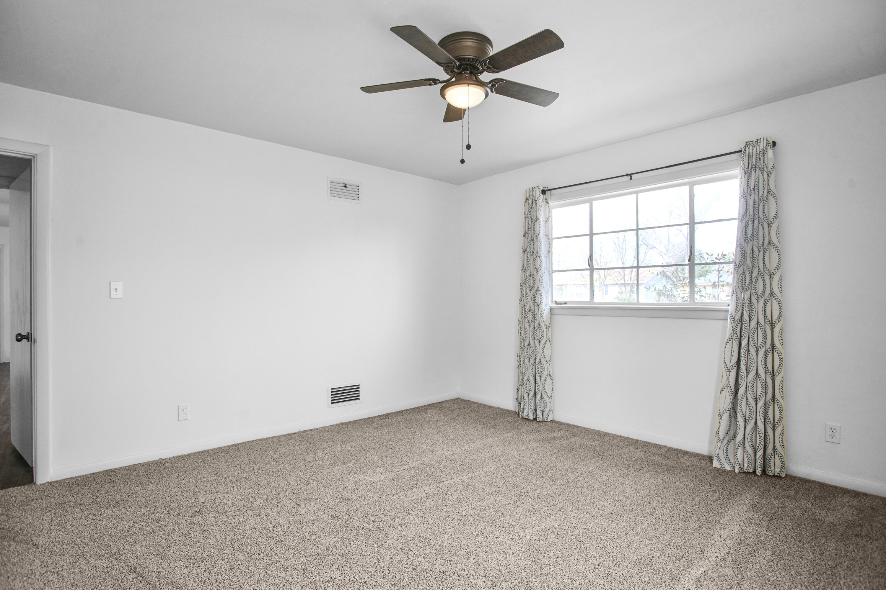 4309 31st Street Lubbock, TX 79410 - Photo 8 of 30 a view of room with hardwood floor and ceiling fan