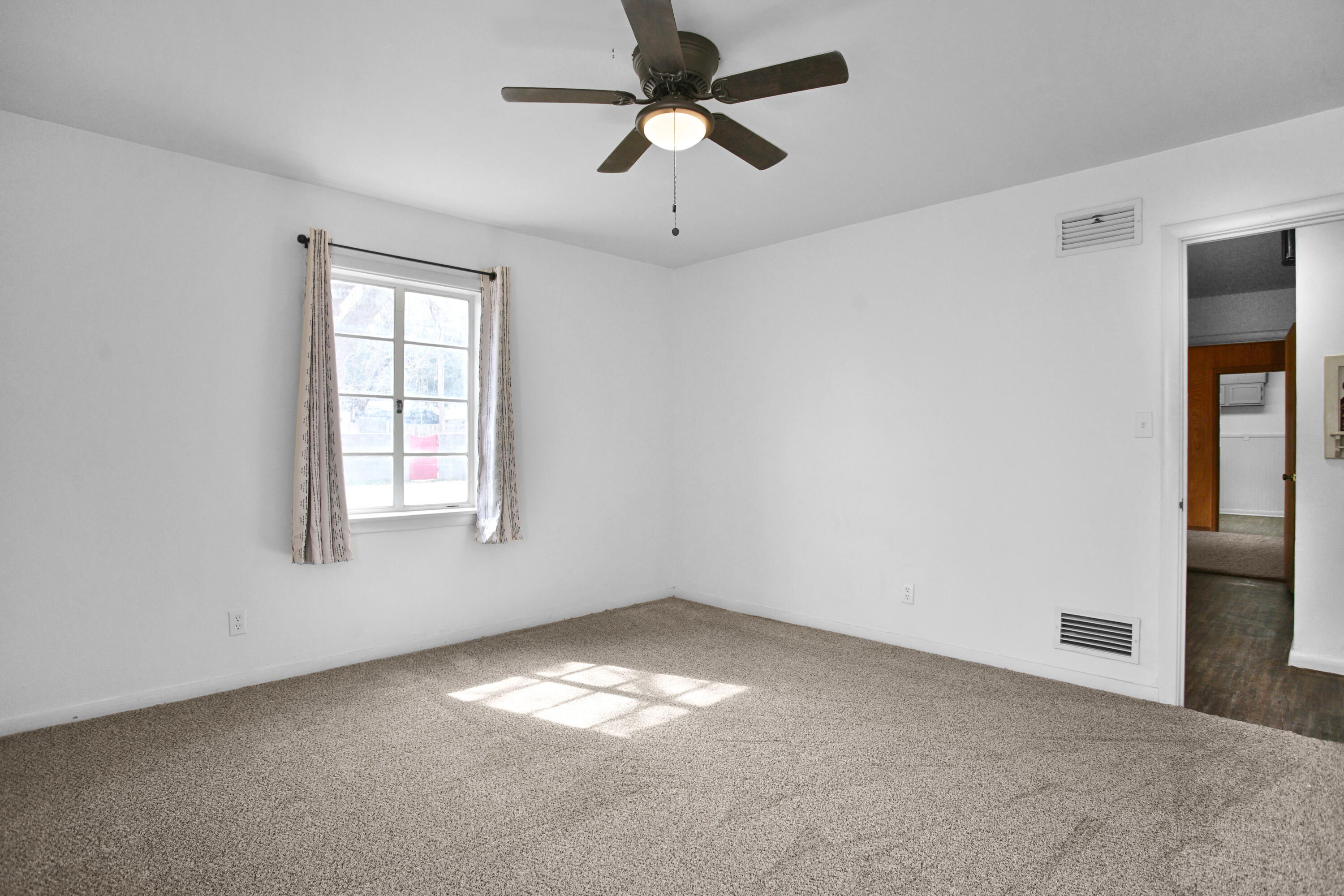 4309 31st Street Lubbock, TX 79410 - Photo 10 of 30 an empty room with windows and fan