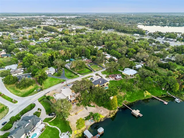 an aerial view of a house with a lake view