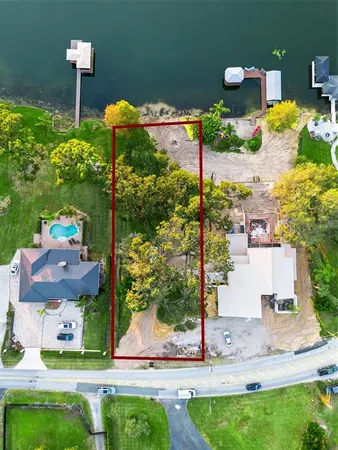 a front view of a house with a yard and tree s