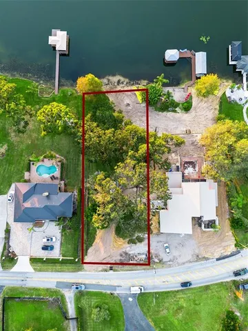 a front view of a house with a yard and tree s