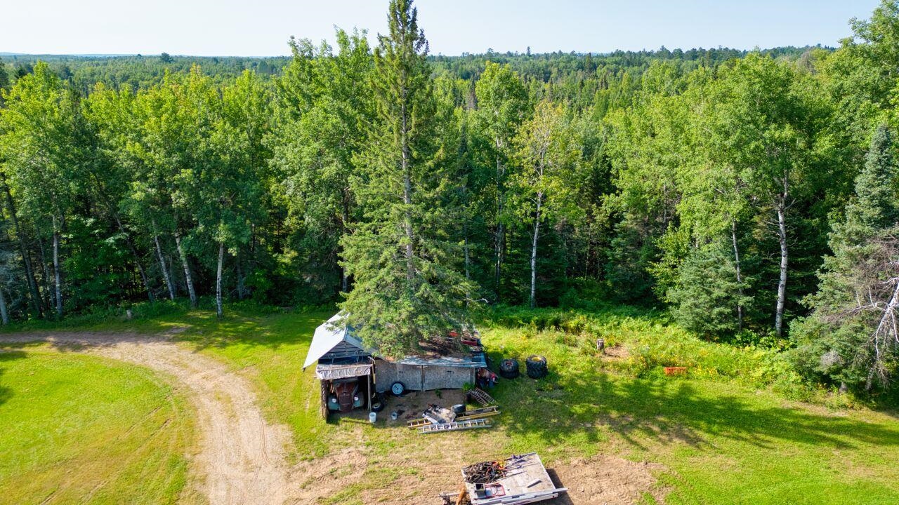 7349 Lax Road Embarrass, MN 55732 - Photo 26 of 36 Aerial view of property and surrounding area featuring a heavily wooded area