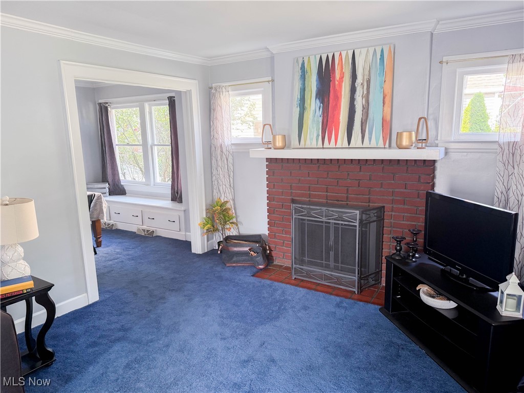4672 Liberty Road South Euclid, OH 44121 - Photo 3 of 23 Living room with crown molding, carpet flooring, and a brick fireplace