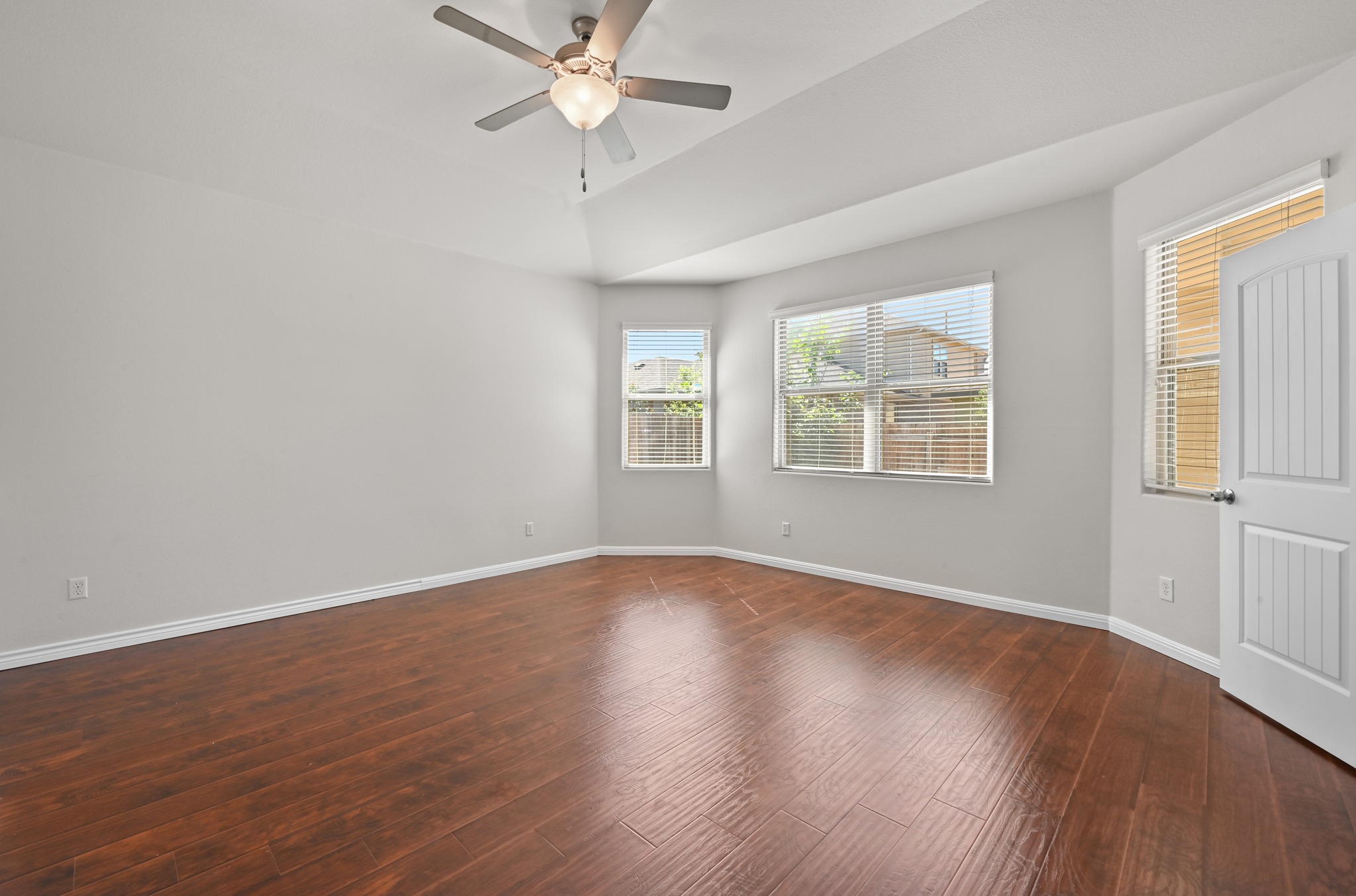 351 Wincliff Drive Buda, TX 78610 - Photo 21 of 40 A quiet bedroom showcases lustrous wood flooring and a refreshing ceiling fan.