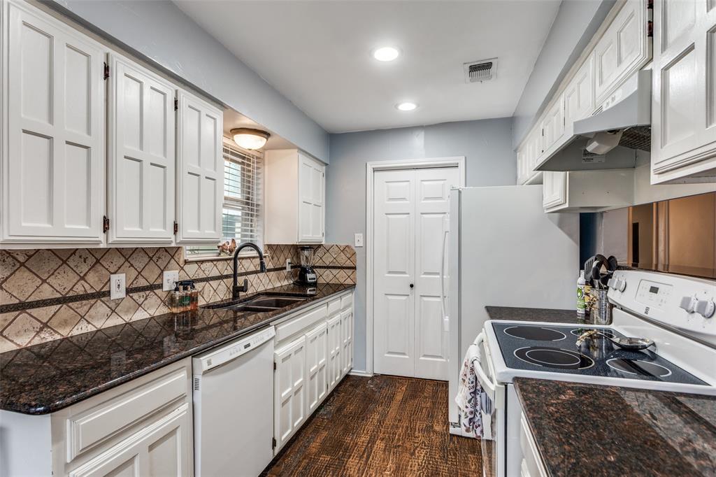 6304 Old Mill Circle Watauga, TX 76148 - Photo 11 of 25 a kitchen with stainless steel appliances granite countertop a sink stove and cabinets