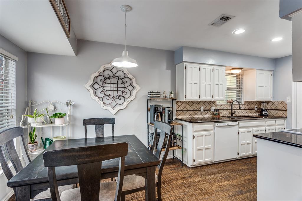 6304 Old Mill Circle Watauga, TX 76148 - Photo 15 of 25 a kitchen with stainless steel appliances a table chairs and chandelier