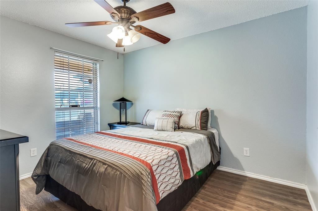 6304 Old Mill Circle Watauga, TX 76148 - Photo 17 of 25 a bedroom with a bed and a chandelier