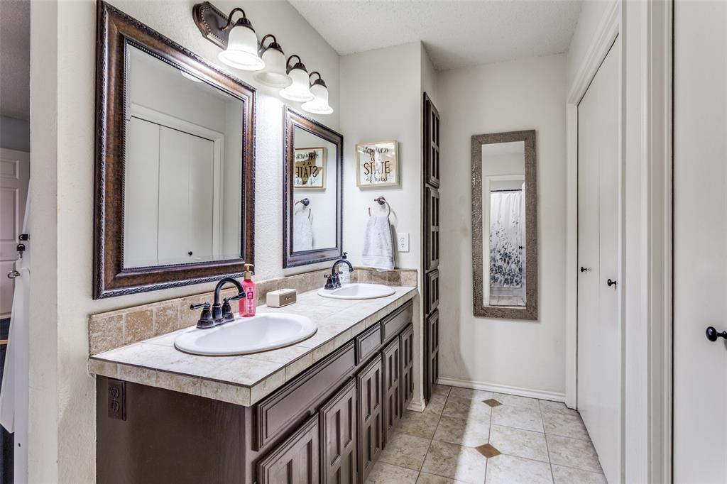 6304 Old Mill Circle Watauga, TX 76148 - Photo 22 of 25 a bathroom with a sink double vanity and a mirror