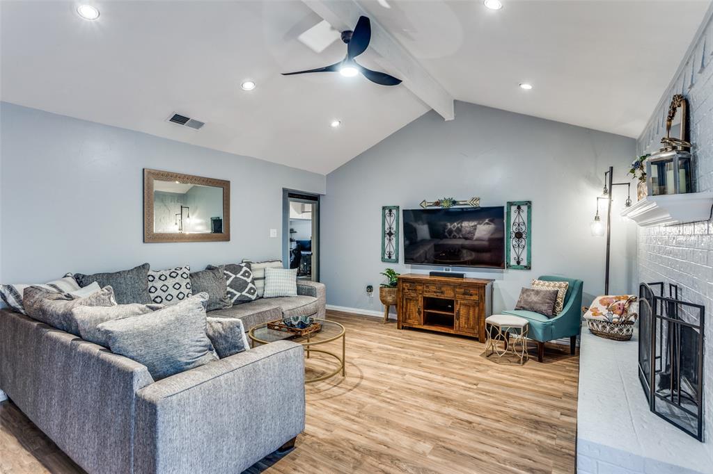 6304 Old Mill Circle Watauga, TX 76148 - Photo 9 of 25 a living room with furniture a flat screen tv and a fireplace