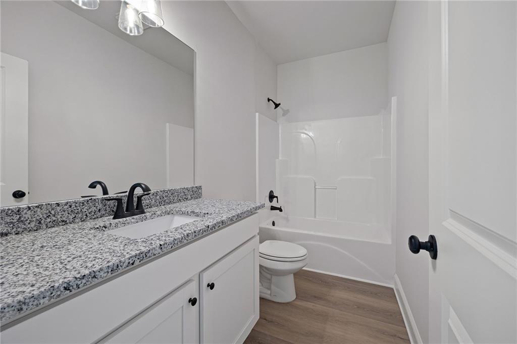 103 Winston Way Carrollton, GA 30117 - Photo 11 of 24 a bathroom with a granite countertop sink toilet and shower