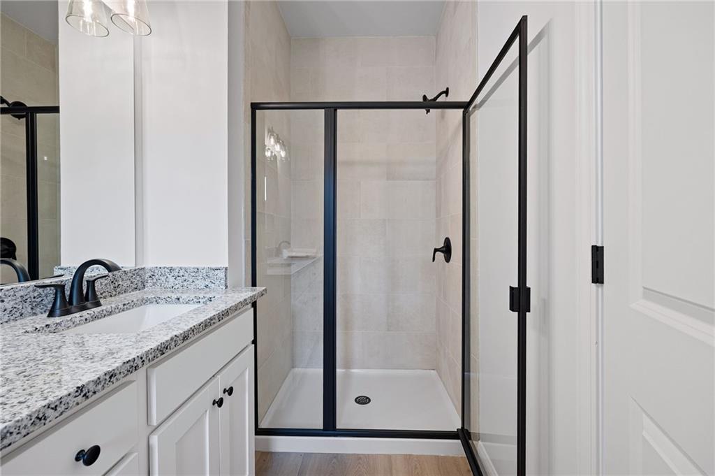 103 Winston Way Carrollton, GA 30117 - Photo 12 of 24 a bathroom with a granite countertop shower sink vanity and mirror
