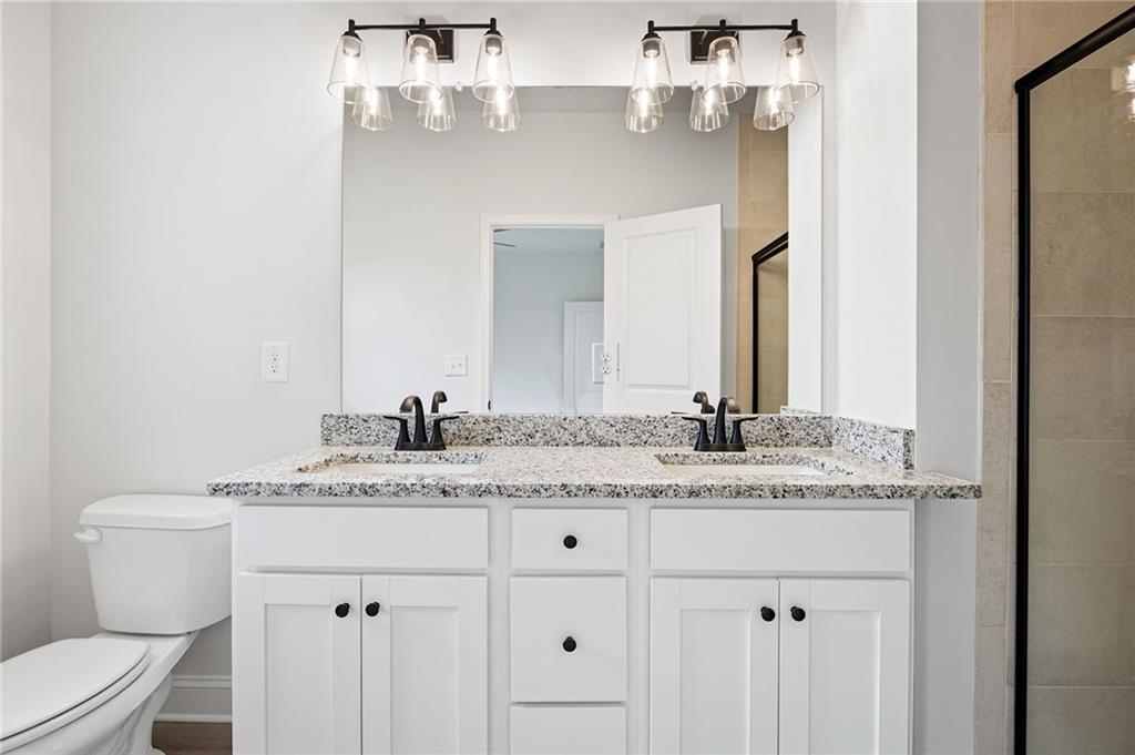 103 Winston Way Carrollton, GA 30117 - Photo 9 of 24 a bathroom with a granite countertop sink and a toilet